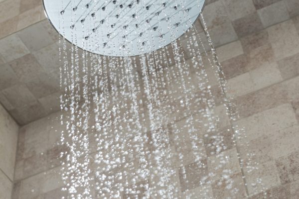 Water running from shower head in bathroom